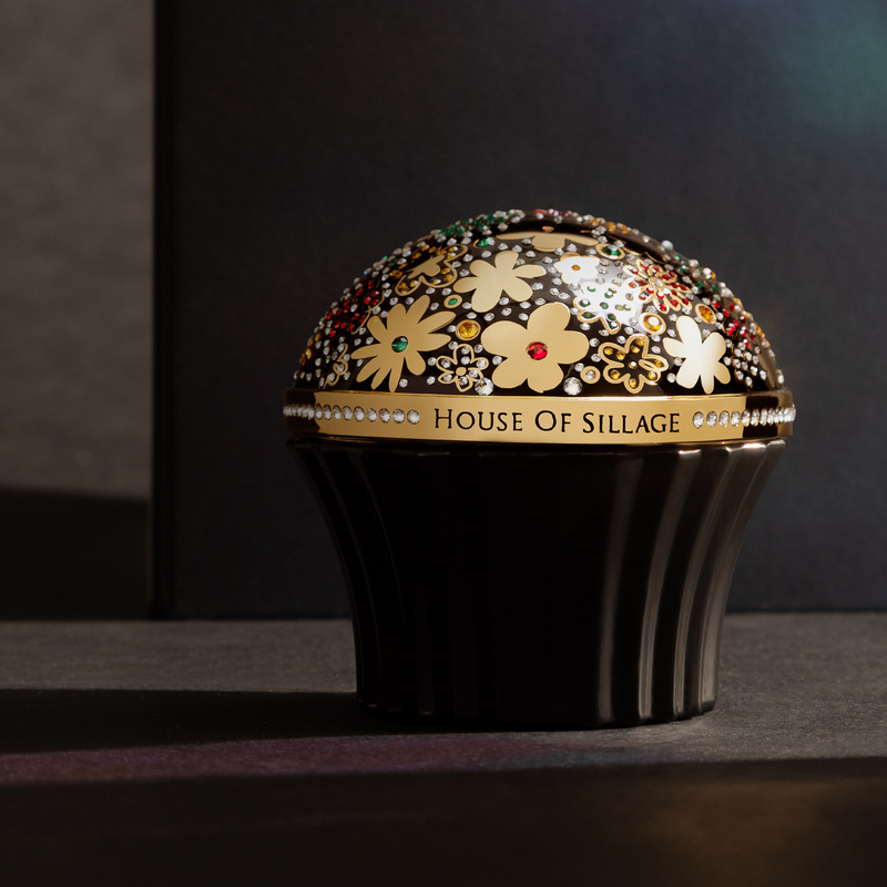 Golden luxury cup with Swarovski crystal covers black fragrance bottle  bottle with perfume